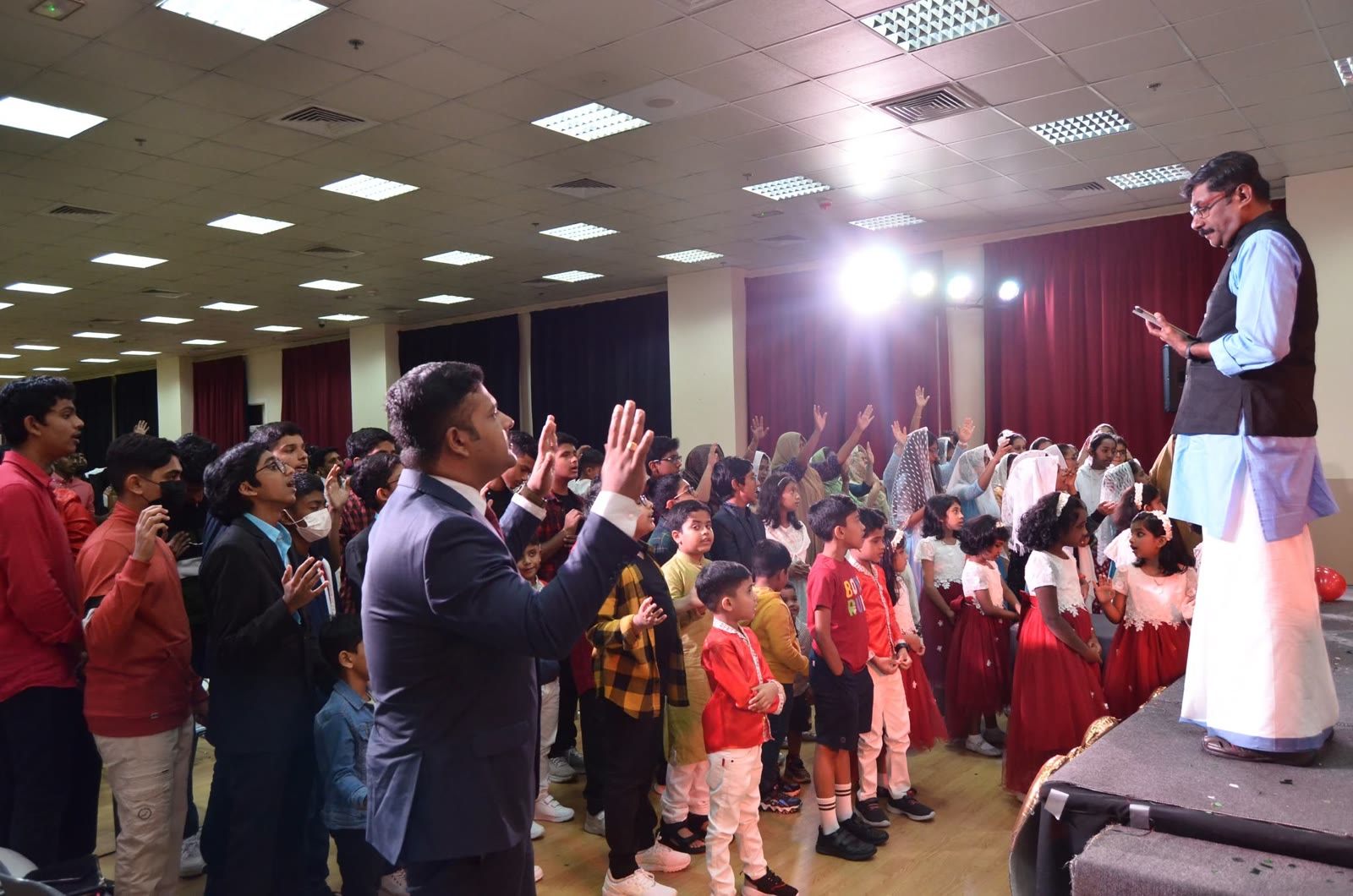 Pastor praying over the children at MERC Kids Church Dubai